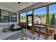 Inviting screened-in porch offering comfortable seating and views of the fireplace and backyard at 105 Aspen Hall Dr, Canton, GA 30115