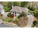 Aerial of the home showing expansive lawn, a circular driveway, and mature, professionally maintained landscaping at 18 Rose Gate Ne Dr, Atlanta, GA 30342