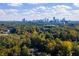 Stunning aerial view of lush green trees with the city skyline in the background at 18 Rose Gate Ne Dr, Atlanta, GA 30342