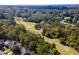 Stunning aerial view of golf course near homes, surrounded by verdant trees at 18 Rose Gate Ne Dr, Atlanta, GA 30342
