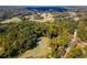 Aerial landscape view of golf course near trees, with winding paths and sand traps adding natural charm at 18 Rose Gate Ne Dr, Atlanta, GA 30342