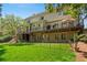 Lush backyard with deck, trees, green grass, outdoor seating and a fenced area, perfect for relaxing at 18 Rose Gate Ne Dr, Atlanta, GA 30342
