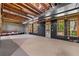 Unfinished basement with wooden ceiling rafters, and black coverings over the windows to the backyard at 18 Rose Gate Ne Dr, Atlanta, GA 30342