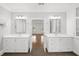 Bright bathroom featuring double vanity, white cabinets, and mirrors with modern lighting at 18 Rose Gate Ne Dr, Atlanta, GA 30342