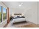 Bright bedroom with hardwood floors, a queen bed and a large window at 18 Rose Gate Ne Dr, Atlanta, GA 30342