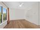 Empty bedroom with hardwood floors, a large window and double door closet at 18 Rose Gate Ne Dr, Atlanta, GA 30342