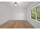 Bright bedroom with hardwood floors, large window, and neutral walls at 18 Rose Gate Ne Dr, Atlanta, GA 30342