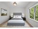 Cozy bedroom with queen bed, hardwood floors, and bright window with a view at 18 Rose Gate Ne Dr, Atlanta, GA 30342
