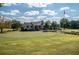Scenic view of a clubhouse overlooking a well-manicured putting green on the golf course at 18 Rose Gate Ne Dr, Atlanta, GA 30342