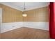 Spacious formal dining room featuring hardwood floors, wainscoting, and wallpaper at 18 Rose Gate Ne Dr, Atlanta, GA 30342