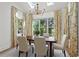 Sunlit dining room with a skylight, dark wood table, seating for six, and botanical print drapes at 18 Rose Gate Ne Dr, Atlanta, GA 30342