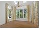 Bright dining room featuring a skylight, dark wood table, seating for six, and botanical print drapes at 18 Rose Gate Ne Dr, Atlanta, GA 30342