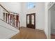 Inviting foyer with a view of the front door and two-story window, hardwood floors, and white trim at 18 Rose Gate Ne Dr, Atlanta, GA 30342