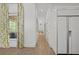Bright hallway featuring hardwood floors and a refrigerator at 18 Rose Gate Ne Dr, Atlanta, GA 30342