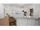 Bright kitchen with white cabinetry, stainless steel appliances, a peninsula island, and barstool seating at 18 Rose Gate Ne Dr, Atlanta, GA 30342