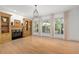 Bright living room featuring a fireplace, built-in shelving, hardwood floors, and large windows with natural light at 18 Rose Gate Ne Dr, Atlanta, GA 30342
