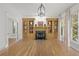 Bright, empty living room with built-in bookshelves, fireplace, hardwood floors, and large windows at 18 Rose Gate Ne Dr, Atlanta, GA 30342