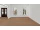 Bright, empty living room featuring hardwood floors, two large windows, and white trim at 18 Rose Gate Ne Dr, Atlanta, GA 30342