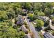 Aerial view of homes in a well-maintained neighborhood with lush greenery and winding streets near a creek at 18 Rose Gate Ne Dr, Atlanta, GA 30342
