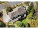 Aerial view showcasing the home's back deck and backyard with lush greenery and patio seating area at 18 Rose Gate Ne Dr, Atlanta, GA 30342