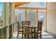 Inviting screened porch featuring a rustic table and chairs, perfect for outdoor dining at 18 Rose Gate Ne Dr, Atlanta, GA 30342