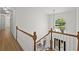 Elegant staircase with wood railings and a large arched window, filling the space with light at 18 Rose Gate Ne Dr, Atlanta, GA 30342