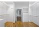 Bright walk-in closet with hardwood floors, shelving, and clothing racks at 18 Rose Gate Ne Dr, Atlanta, GA 30342