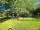 Fenced backyard has maintained grass and shady spot with trees, perfect for pets or play at 213 Mccready Dr, Dallas, GA 30157