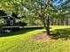 Large backyard features a mature shade tree and level grassy area, great for outdoor activities at 213 Mccready Dr, Dallas, GA 30157
