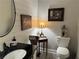 A well-appointed bathroom features shiplap walls, a black countertop sink, and decorative wall art at 213 Mccready Dr, Dallas, GA 30157