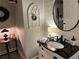A decorative bathroom with a black countertop sink, brick floors, and stylish accent pieces at 213 Mccready Dr, Dallas, GA 30157