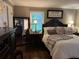 Well-lit bedroom featuring a comfortable bed, dark furniture, and decorative accents at 213 Mccready Dr, Dallas, GA 30157
