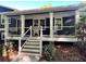 Inviting front porch with rocking chairs, decorative columns, and elegant stone accents at 213 Mccready Dr, Dallas, GA 30157
