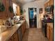 Well-lit kitchen featuring wooden cabinetry, stainless steel appliances, and a view into the dining room at 213 Mccready Dr, Dallas, GA 30157