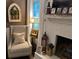 Cozy living room featuring a comfortable chair and a charming fireplace with decorative accents at 213 Mccready Dr, Dallas, GA 30157