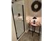 Shower stall features white tile, glass door, and antique wood table with lamp at 213 Mccready Dr, Dallas, GA 30157