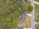 Birds-eye view of home nestled in wooded neighborhood, featuring long driveway and mature trees at 315 Fieldridge Dr, Lawrenceville, GA 30045