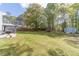 Spacious backyard featuring a shed, large lawn, patio and wooded border at 315 Fieldridge Dr, Lawrenceville, GA 30045