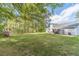 Large backyard with mature trees, a manicured lawn, and a view of the rear of the home at 315 Fieldridge Dr, Lawrenceville, GA 30045