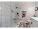 Modern bathroom featuring a glass-enclosed shower with white tile surround and a white vanity with a quartz countertop at 315 Fieldridge Dr, Lawrenceville, GA 30045