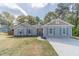 Charming single-story home with light blue siding, shutters, and manicured front lawn at 315 Fieldridge Dr, Lawrenceville, GA 30045