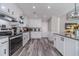 Updated kitchen boasts white cabinets, modern appliances, and beautiful granite countertops at 315 Fieldridge Dr, Lawrenceville, GA 30045