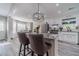 Bright kitchen with a large island featuring bar stool seating and modern lighting fixture at 315 Fieldridge Dr, Lawrenceville, GA 30045