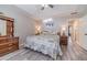 Well-lit main bedroom with neutral colors, featuring a ceiling fan, dresser, and hardwood flooring at 315 Fieldridge Dr, Lawrenceville, GA 30045