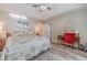 Spacious main bedroom featuring a tray ceiling, ceiling fan, and hardwood floors for a comfortable retreat at 315 Fieldridge Dr, Lawrenceville, GA 30045