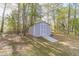 Charming storage shed featuring white trim, double doors, and a convenient ramp, ideal for storage and accessibility at 315 Fieldridge Dr, Lawrenceville, GA 30045