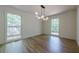 Sunlit bedroom with large windows and a modern light fixture at 3350 Pine Meadow Nw Rd, Atlanta, GA 30327