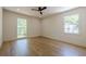 An airy bedroom featuring pristine hardwood floors, large windows, and a modern ceiling fan at 3350 Pine Meadow Nw Rd, Atlanta, GA 30327