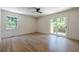 Bedroom featuring light hardwood floors, neutral walls, a sliding glass door, and ceiling fan at 3350 Pine Meadow Nw Rd, Atlanta, GA 30327