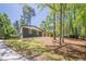 A beautiful home sits on a wooded lot with a long driveway and grass at 3350 Pine Meadow Nw Rd, Atlanta, GA 30327